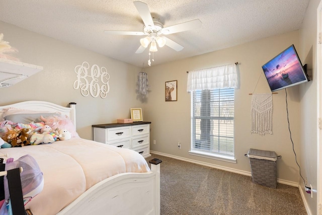 bedroom featuring ceiling fan, dark carpet, and a textured ceiling