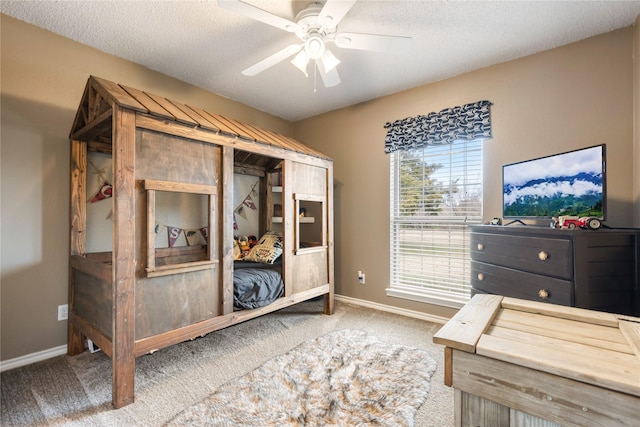 bedroom with carpet flooring, ceiling fan, and a textured ceiling