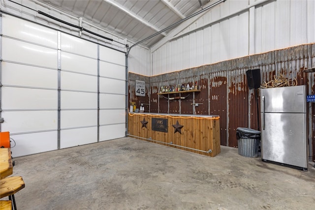 garage featuring a workshop area and stainless steel fridge