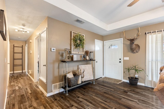 foyer entrance with ceiling fan and dark hardwood / wood-style flooring