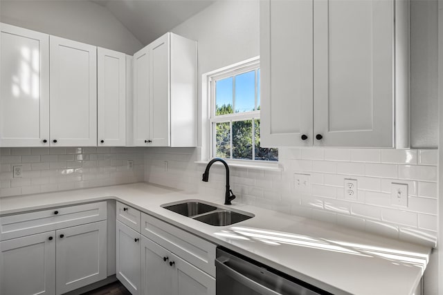 kitchen with decorative backsplash, sink, white cabinets, and lofted ceiling