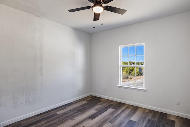 empty room with ceiling fan and dark hardwood / wood-style floors