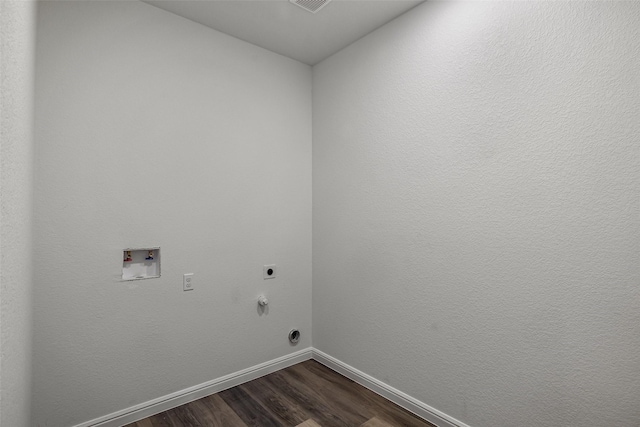 clothes washing area with hardwood / wood-style flooring, electric dryer hookup, hookup for a gas dryer, and hookup for a washing machine