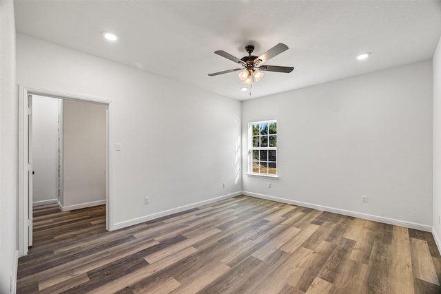 unfurnished room with dark hardwood / wood-style flooring and ceiling fan