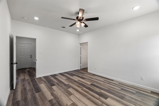 spare room with ceiling fan and dark hardwood / wood-style flooring