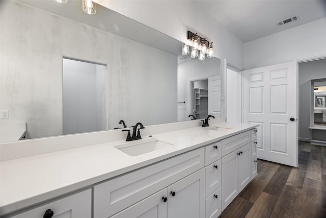 bathroom with hardwood / wood-style floors and vanity