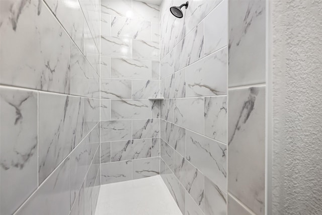 bathroom with a tile shower