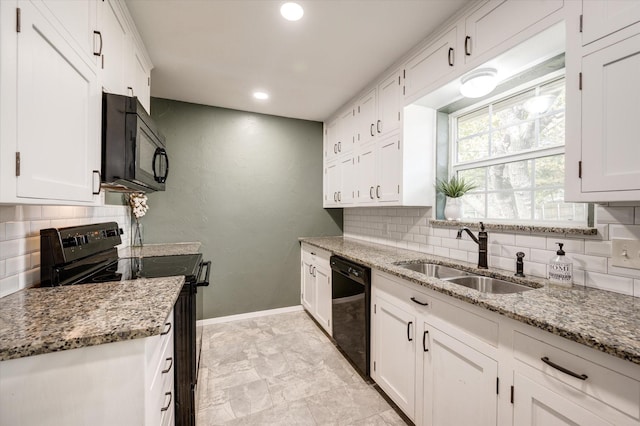 kitchen featuring black appliances, sink, light stone countertops, tasteful backsplash, and white cabinetry