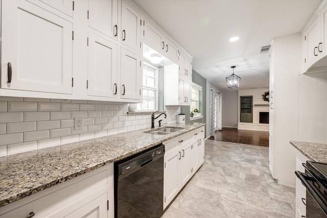 kitchen with white cabinetry, sink, and black dishwasher