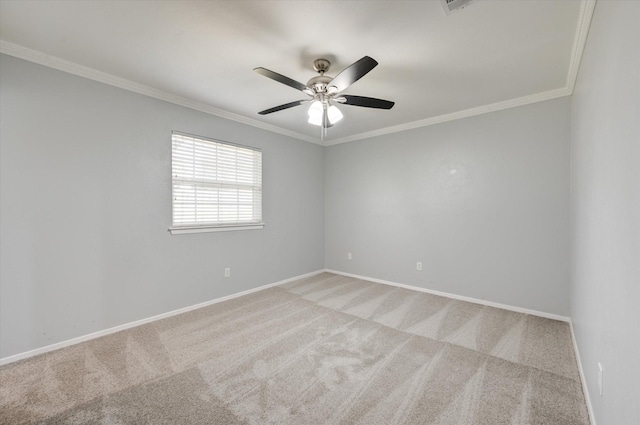 carpeted spare room featuring ceiling fan and ornamental molding