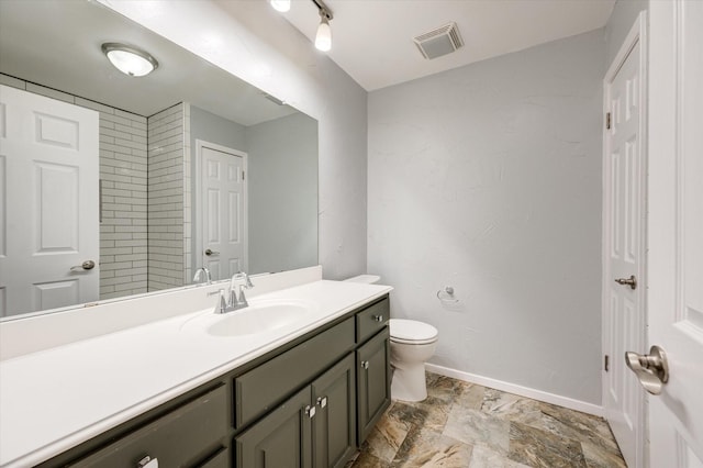 bathroom featuring vanity and toilet