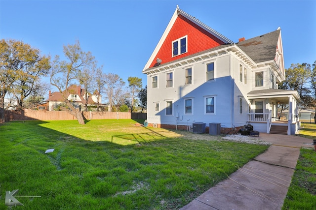 view of property exterior featuring cooling unit, a yard, and covered porch