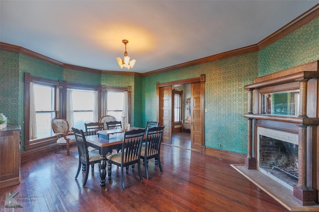 dining space with dark wood-type flooring, crown molding, and a chandelier