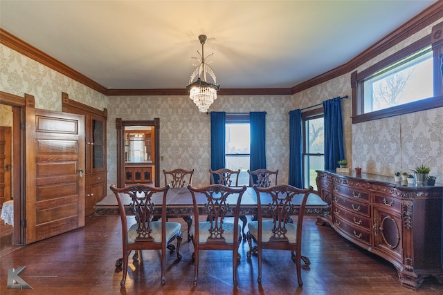 dining room with ornamental molding, dark hardwood / wood-style floors, and a notable chandelier