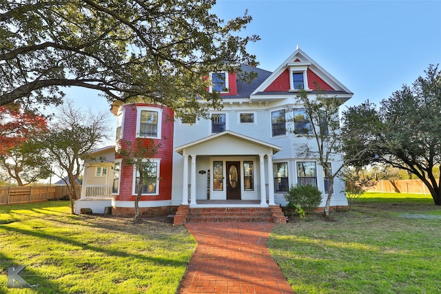 victorian home with a porch and a front yard