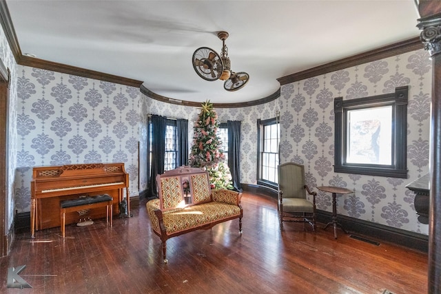 sitting room with ornamental molding and dark hardwood / wood-style floors