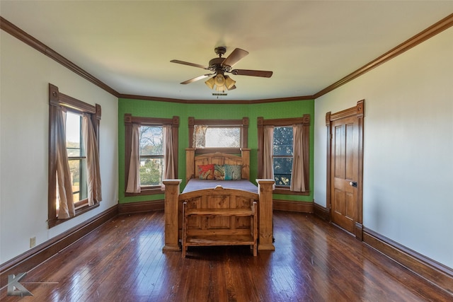 bedroom featuring crown molding, dark wood-type flooring, and ceiling fan