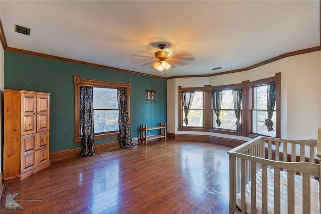 bedroom featuring dark wood-type flooring, ceiling fan, and ornamental molding