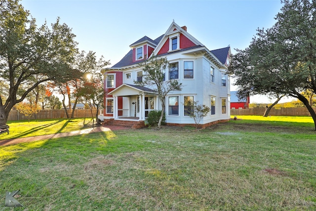 victorian home with a front lawn