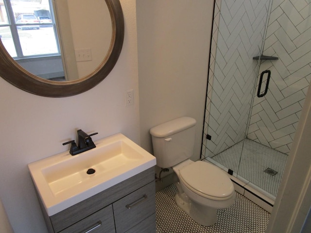 bathroom featuring vanity, an enclosed shower, tile patterned floors, and toilet