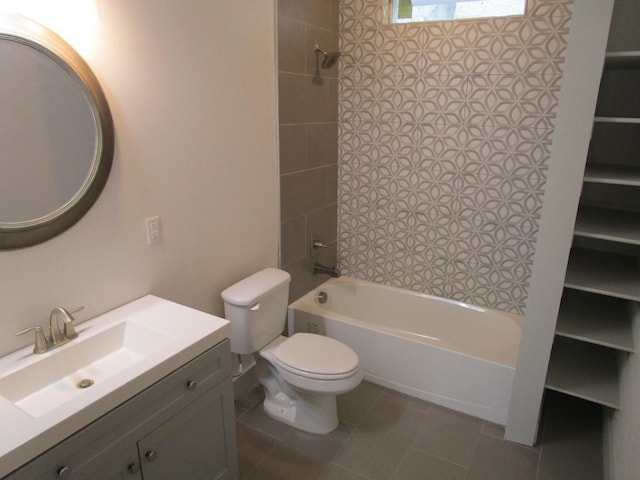 full bathroom featuring vanity, tiled shower / bath combo, tile patterned floors, and toilet