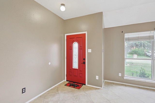 foyer entrance with light tile patterned flooring