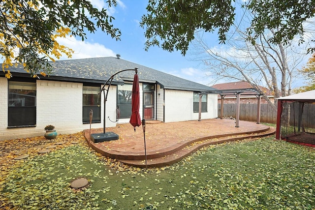 rear view of property with a pergola, a gazebo, and a patio