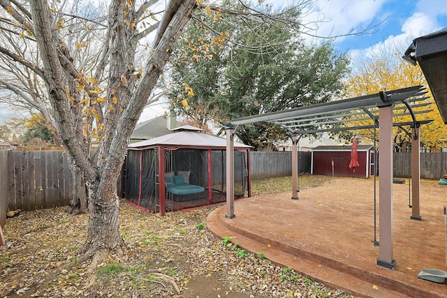 view of yard featuring a pergola, a gazebo, and a storage shed