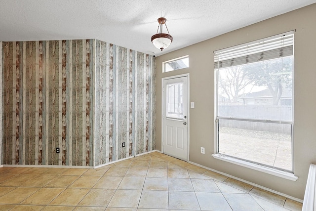 tiled foyer entrance featuring a textured ceiling