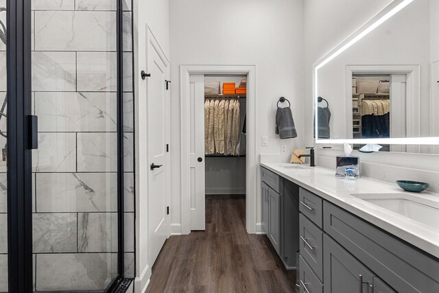 bathroom featuring vanity, wood-type flooring, and an enclosed shower