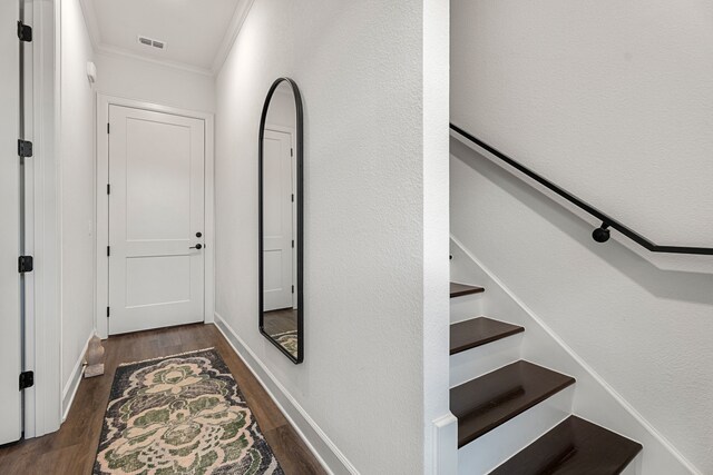 hallway featuring dark hardwood / wood-style flooring and ornamental molding