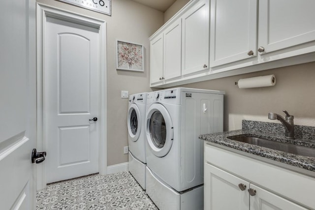 washroom featuring washer and dryer, light tile patterned floors, cabinets, and sink