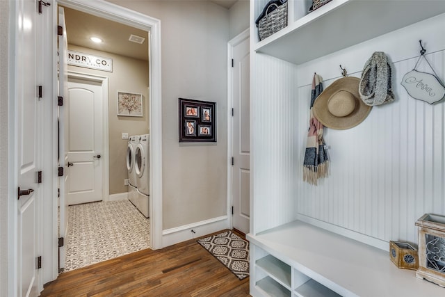 mudroom with washing machine and clothes dryer and dark hardwood / wood-style flooring