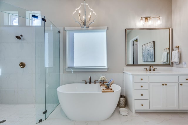 bathroom featuring vanity, plenty of natural light, plus walk in shower, and an inviting chandelier