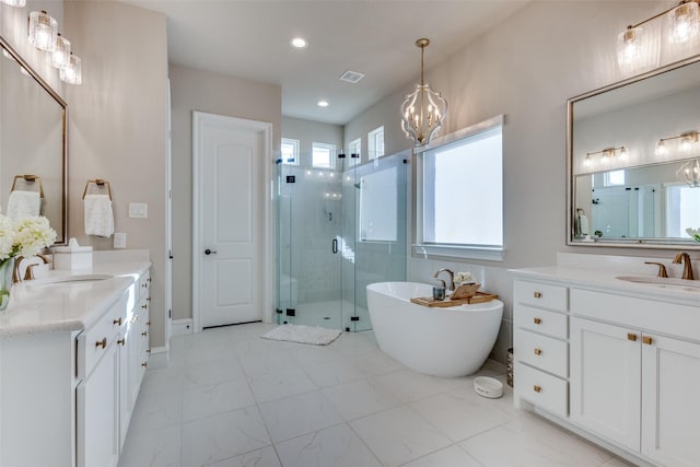 bathroom with vanity, a notable chandelier, and shower with separate bathtub