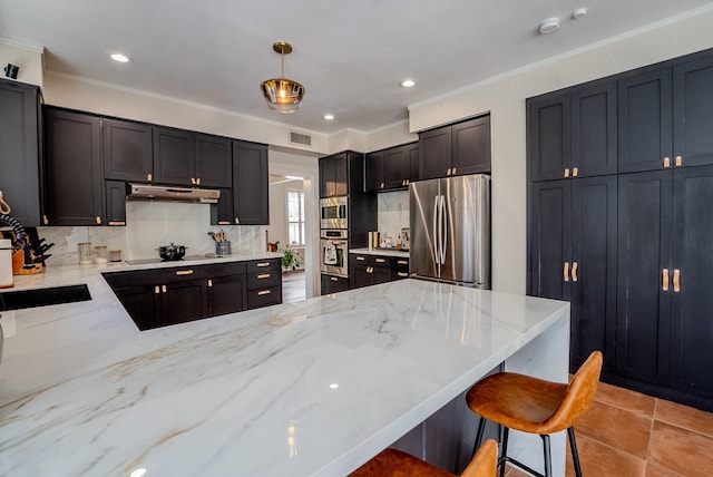 kitchen featuring pendant lighting, stainless steel appliances, light stone counters, and crown molding