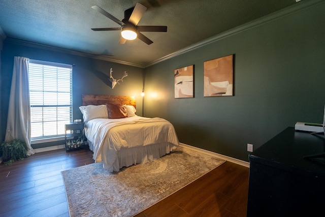 bedroom with a textured ceiling, crown molding, ceiling fan, and dark wood-type flooring