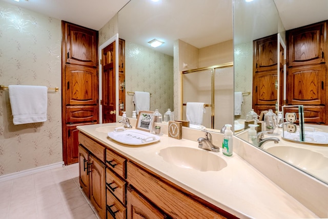 bathroom with tile patterned floors, vanity, and walk in shower