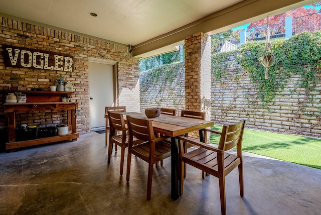 dining space with brick wall