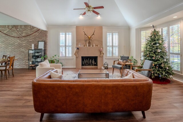 living room featuring crown molding, ceiling fan, lofted ceiling, and hardwood / wood-style flooring