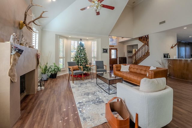 living room with dark hardwood / wood-style floors, high vaulted ceiling, ceiling fan, and crown molding