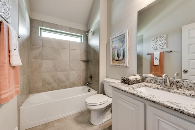 full bathroom featuring vanity, lofted ceiling, tile patterned floors, tiled shower / bath, and toilet