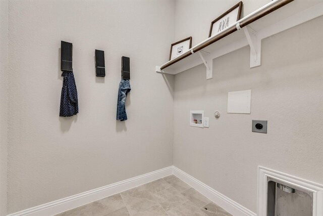 clothes washing area featuring washer hookup, electric dryer hookup, gas dryer hookup, and light tile patterned floors