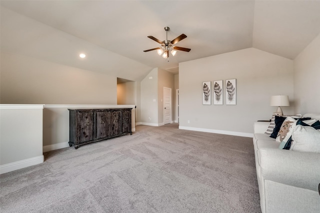 carpeted living room with ceiling fan and lofted ceiling