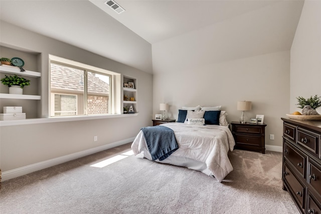 carpeted bedroom with lofted ceiling