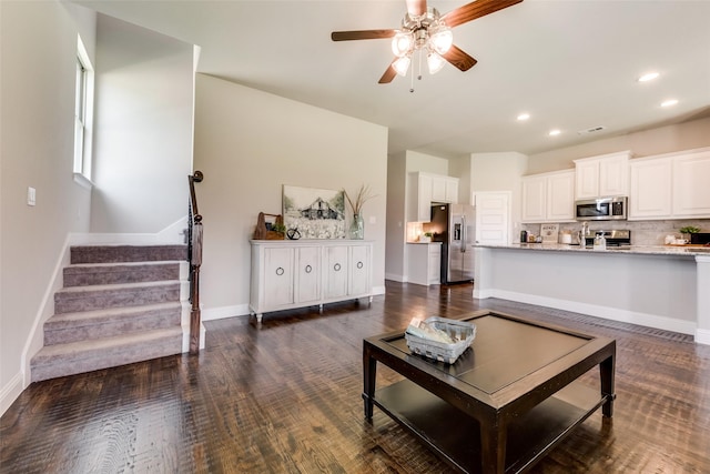 living room featuring sink, dark hardwood / wood-style floors, and ceiling fan