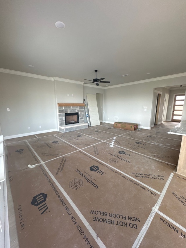 unfurnished living room featuring crown molding and ceiling fan