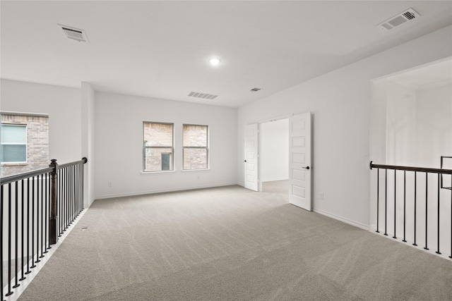 unfurnished room with light colored carpet