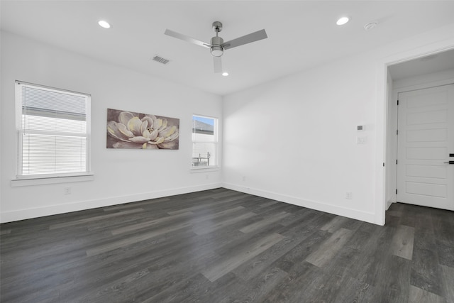 unfurnished room with dark hardwood / wood-style floors, ceiling fan, and a wealth of natural light