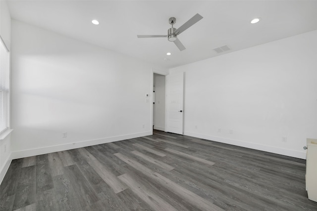 empty room featuring ceiling fan and dark wood-type flooring